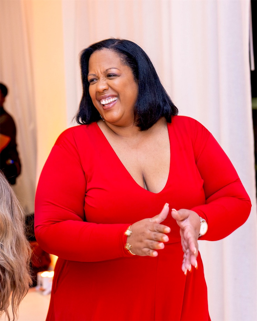 Queen B laughing in red