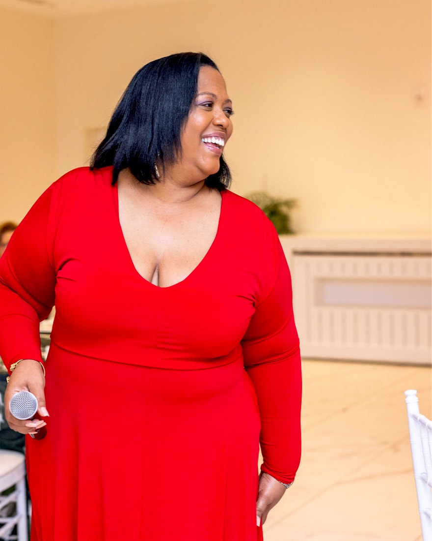 Queen B smiling in red