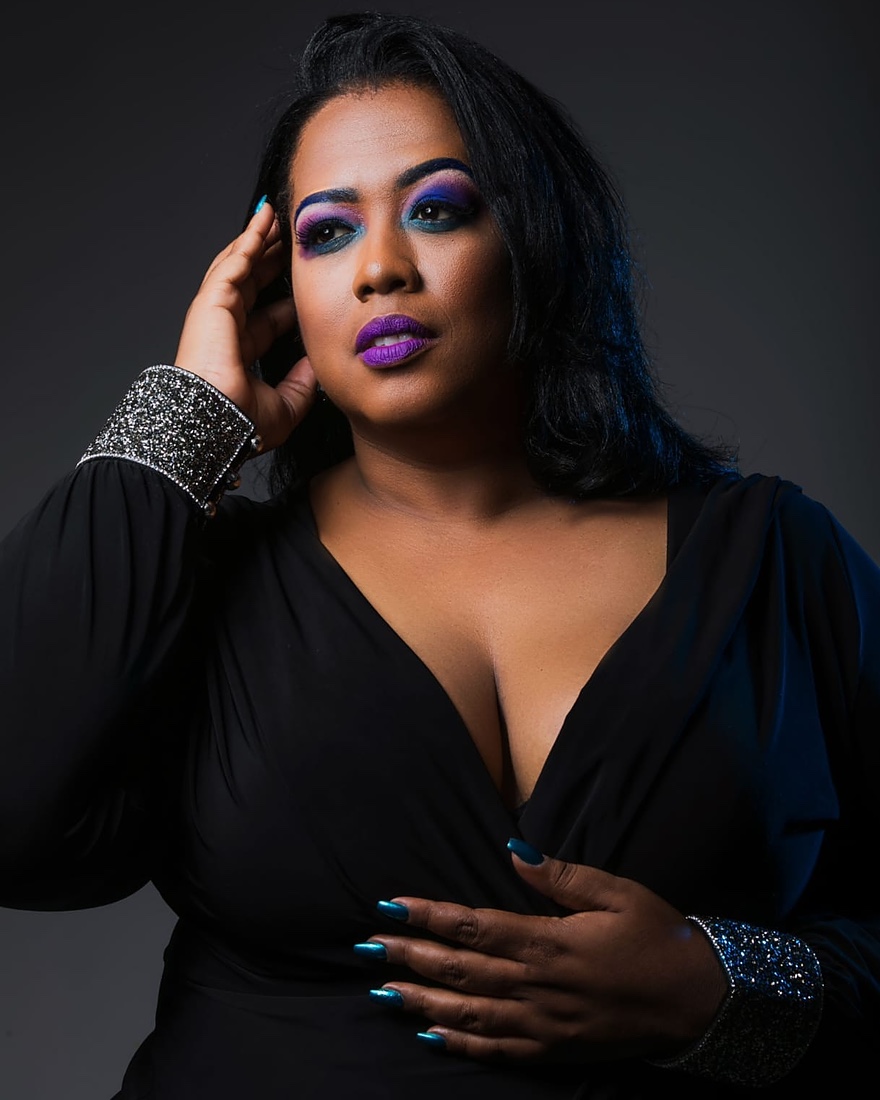 Queen B studio portrait in black with silver cuffs