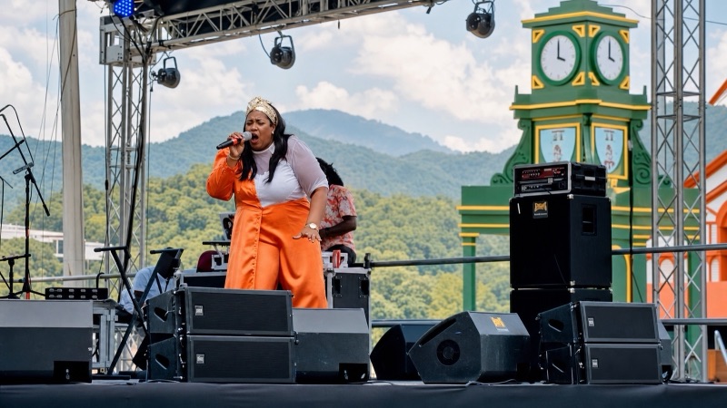Queen B performing My Shoes on an outdoor festival stage