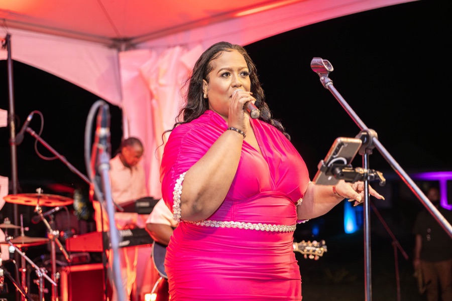 Queen B in pink with her band under the festival tent