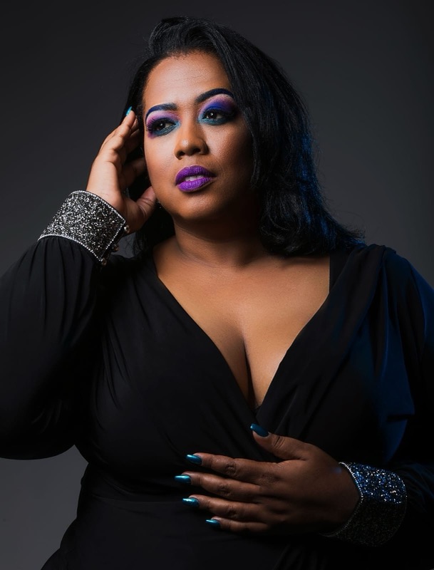 Queen B studio portrait in black with silver cuffs