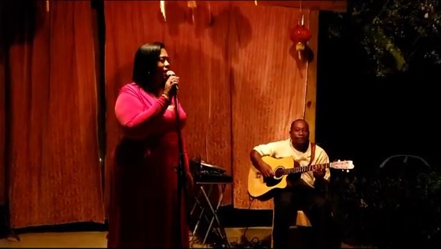 Queen B singing an acoustic set with guitar accompaniment